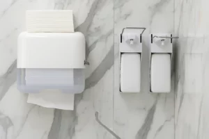Soap dispensers are mounted on a wall alongside a paper towel Stock Photo, ft. accessibility & area - Envato