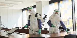Two People Disinfecting Office